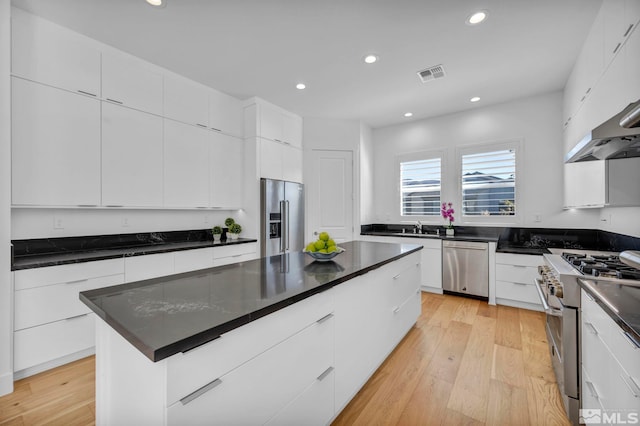2277 White Clay Dr, Reno, NV 89521 - kitchen featuring high end appliances, recessed lighting, modern cabinets, dark countertops, and white cabinets