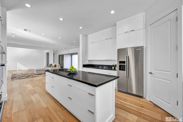 2277 White Clay Dr, Reno, NV 89521 - kitchen with high quality fridge, modern cabinets, recessed lighting, dark countertops, and light wood-style floors
