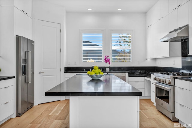 2277 White Clay Dr, Reno, NV 89521 - kitchen with appliances with stainless steel finishes, dark countertops, under cabinet range hood, recessed lighting, and white cabinetry