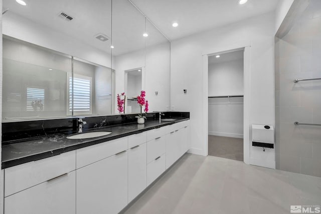 2277 White Clay Dr, Reno, NV 89521 - bathroom with a walk in closet, double vanity, and recessed lighting