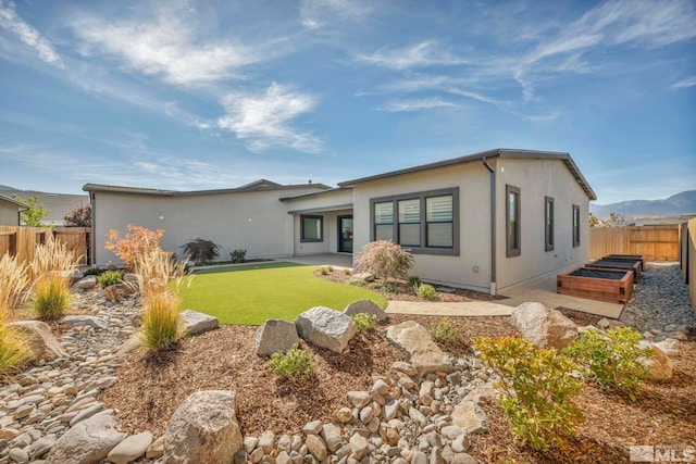 2277 White Clay Dr, Reno, NV 89521 - rear view of property with stucco siding, a garden, and a patio