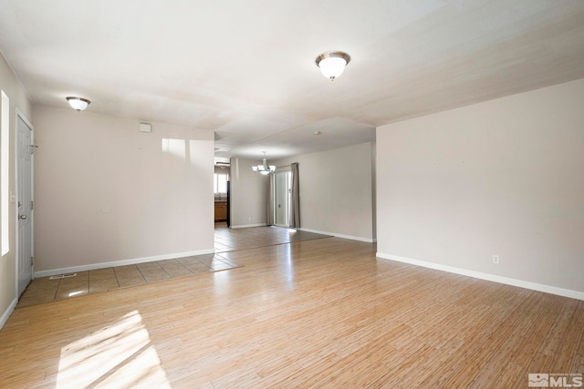 1342 Cahi Cir, Gardnerville, NV 89460 - empty room with a chandelier, light wood-style flooring, and baseboards