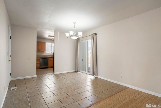 1342 Cahi Cir, Gardnerville, NV 89460 - empty room featuring a chandelier, baseboards, light tile patterned flooring, and a sink