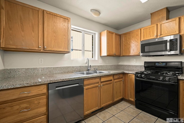 1342 Cahi Cir, Gardnerville, NV 89460 - kitchen with appliances with stainless steel finishes, a sink, light tile patterned floors, and brown cabinetry