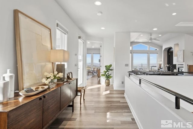 10241 Zuni Ridge Trl, Reno, NV 89511 - corridor featuring healthy amount of natural light, recessed lighting, vaulted ceiling, light wood-style flooring, and baseboards