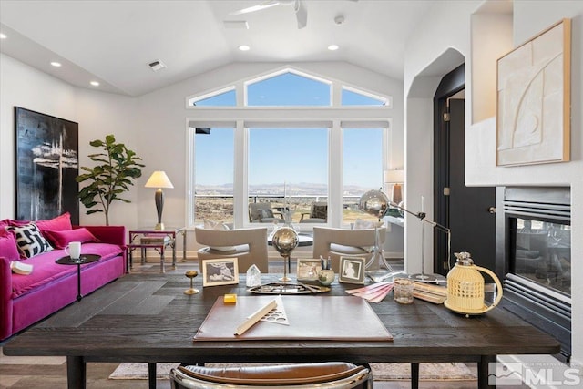 10241 Zuni Ridge Trl, Reno, NV 89511 - dining space with vaulted ceiling, recessed lighting, and a glass covered fireplace