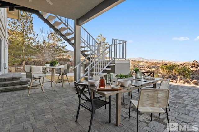 10241 Zuni Ridge Trl, Reno, NV 89511 - view of patio with outdoor dining area, stairs, and a mountain view