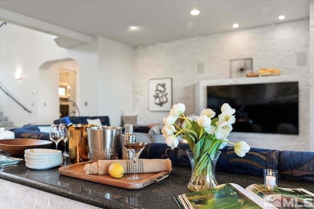 10241 Zuni Ridge Trl, Reno, NV 89511 - living area with arched walkways, recessed lighting, and stairway