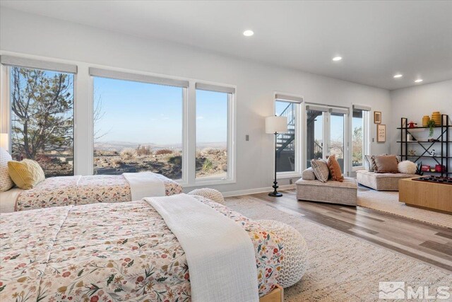 10241 Zuni Ridge Trl, Reno, NV 89511 - bedroom featuring wood finished floors, recessed lighting, multiple windows, baseboards, and access to exterior