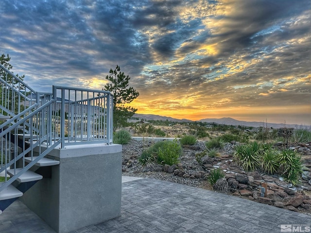 10241 Zuni Ridge Trl, Reno, NV 89511 - patio terrace at dusk featuring stairs and a mountain view