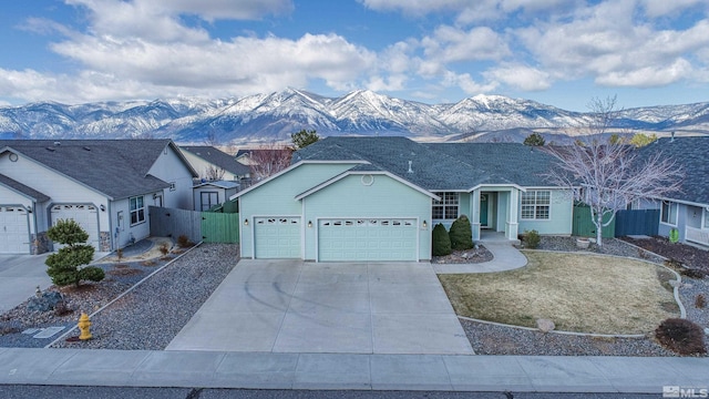 2976 Del Rio Ln, Minden, NV 89423 - single story home featuring an attached garage, fence, driveway, and a mountain view