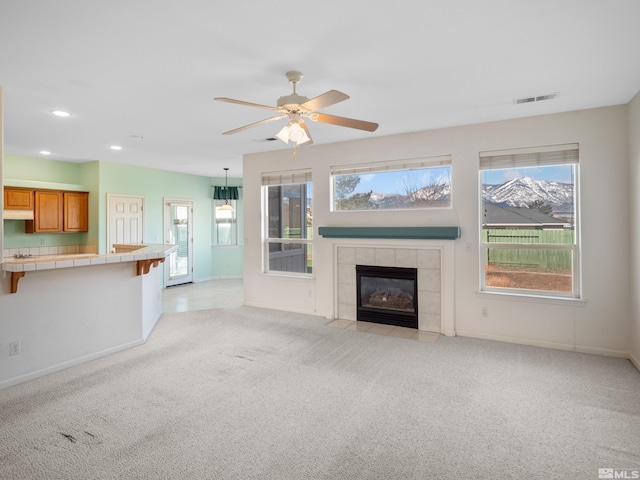 2976 Del Rio Ln, Minden, NV 89423 - unfurnished living room featuring a fireplace, light carpet, baseboards, ceiling fan, and recessed lighting