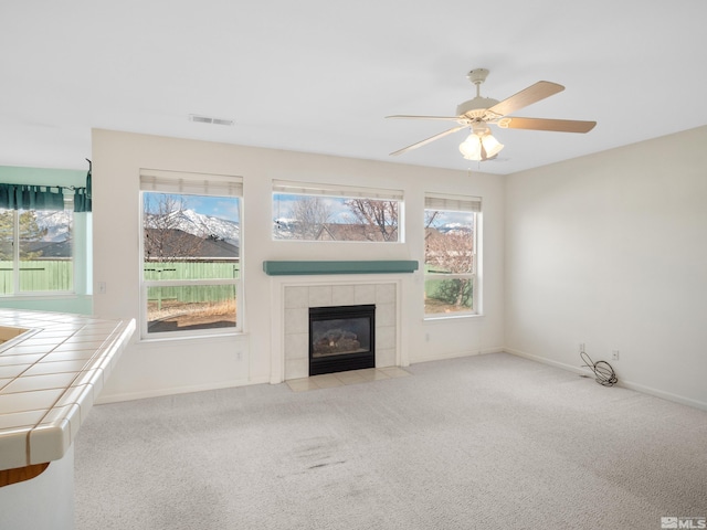 2976 Del Rio Ln, Minden, NV 89423 - unfurnished living room featuring carpet, a tiled fireplace, and baseboards