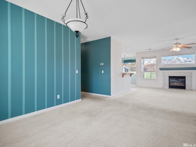 2976 Del Rio Ln, Minden, NV 89423 - unfurnished living room with carpet floors, a ceiling fan, a tile fireplace, and baseboards