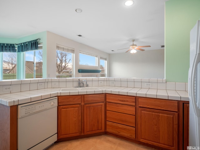 2976 Del Rio Ln, Minden, NV 89423 - kitchen with white appliances, a sink, a ceiling fan, brown cabinets, and recessed lighting