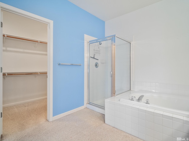 2976 Del Rio Ln, Minden, NV 89423 - bathroom featuring a stall shower, a spacious closet, and a bath