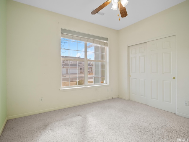 2976 Del Rio Ln, Minden, NV 89423 - unfurnished bedroom featuring carpet flooring, baseboards, a closet, and a ceiling fan