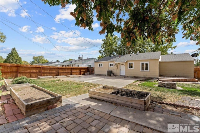 1180 Xman Way, Sparks, NV 89431 - rear view of house featuring a fire pit, a garden, a patio, and central AC