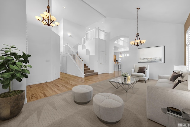 6841 Talmedge Cir, Sparks, NV 89436 - living room featuring a chandelier, high vaulted ceiling, wood finished floors, stairs, and baseboards