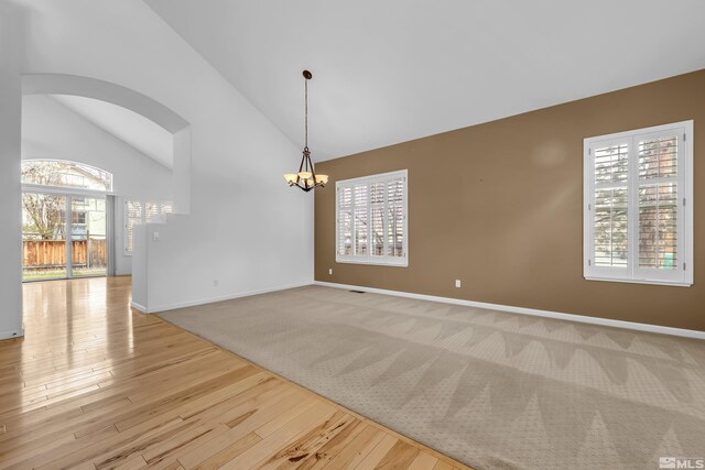 6841 Talmedge Cir, Sparks, NV 89436 - spare room with a chandelier, healthy amount of natural light, baseboards, and high vaulted ceiling