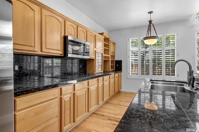 6841 Talmedge Cir, Sparks, NV 89436 - kitchen with appliances with stainless steel finishes, a sink, backsplash, light wood-style floors, and decorative light fixtures