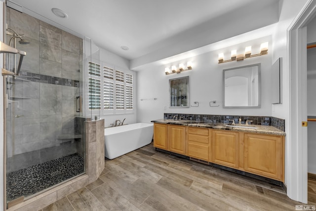 6841 Talmedge Cir, Sparks, NV 89436 - full bath with double vanity, a shower stall, a freestanding tub, and wood finished floors