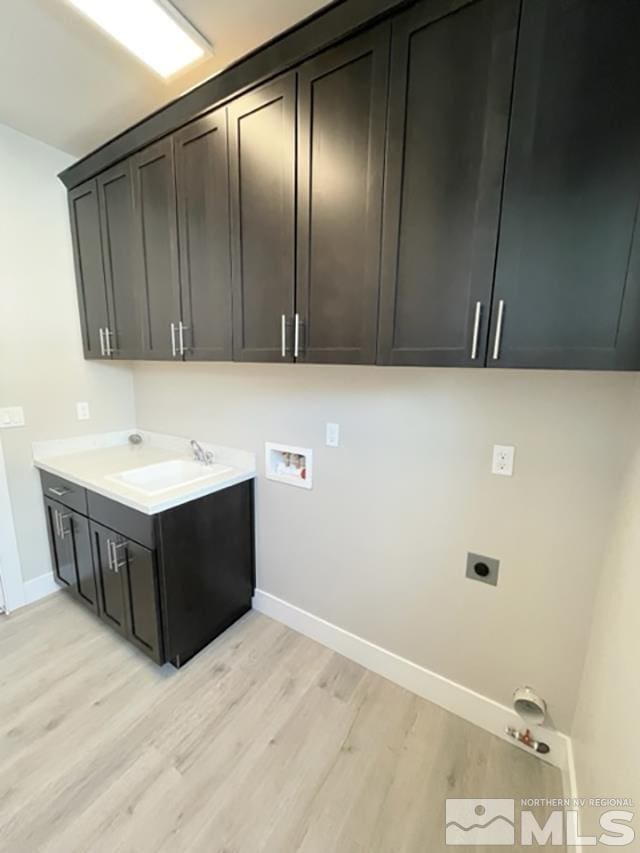 1608 Delta Downs Dr Unit 61, Minden, NV 89423 - washroom featuring cabinet space, light wood-type flooring, baseboards, and hookup for a washing machine