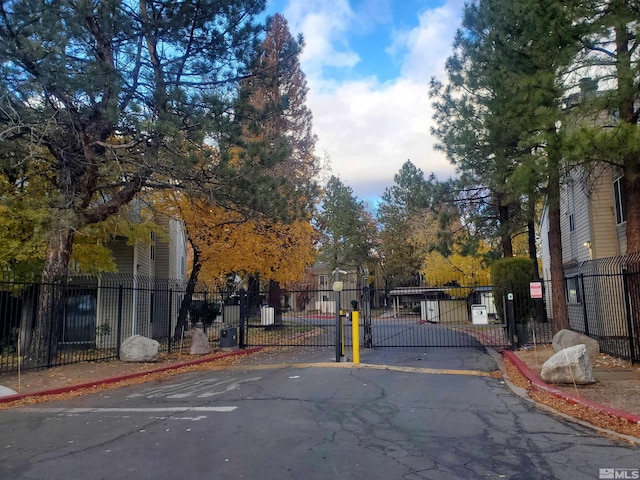 2341 Roundhouse Rd, Sparks, NV 89431 - view of asphalt road featuring curbs, a gated entry, a gate, and sidewalks