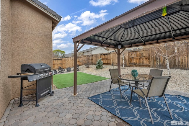 132 Egan Ave, Dayton, NV 89403 - view of patio with area for grilling, a gazebo, a fenced backyard, and outdoor dining space