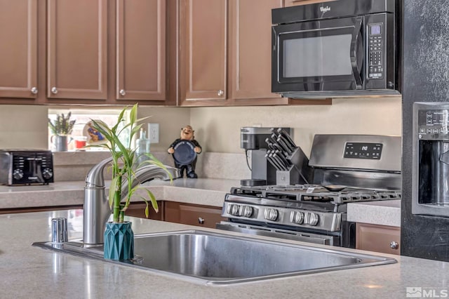 132 Egan Ave, Dayton, NV 89403 - kitchen with black microwave, a sink, and light countertops