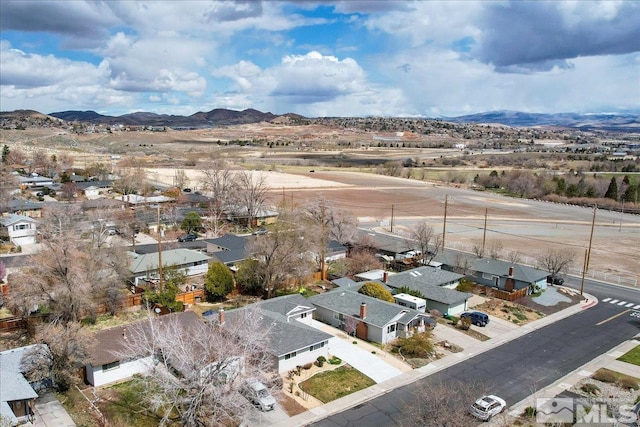 aerial view of residential area featuring mountains