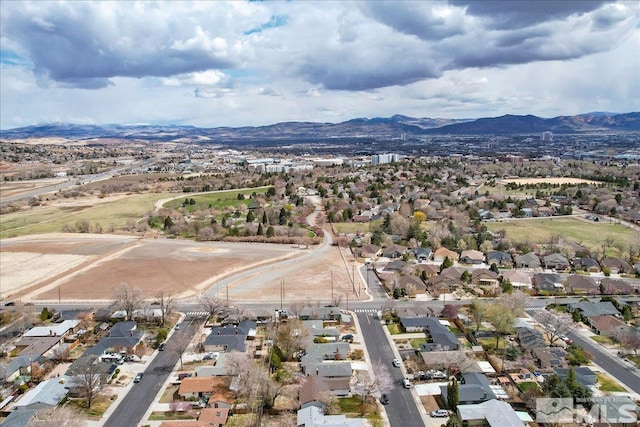view of property location with mountains and nearby suburban area