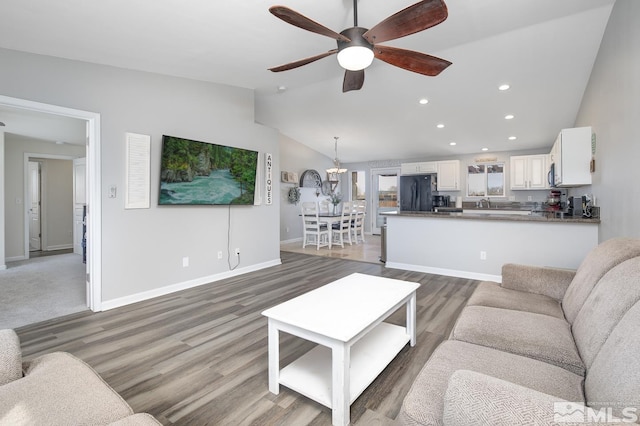 261 Brent St, Fallon, NV 89406 - living room featuring lofted ceiling, a ceiling fan, recessed lighting, baseboards, and light wood-style floors