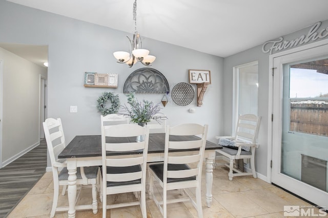 261 Brent St, Fallon, NV 89406 - dining area with a chandelier, baseboards, and vaulted ceiling