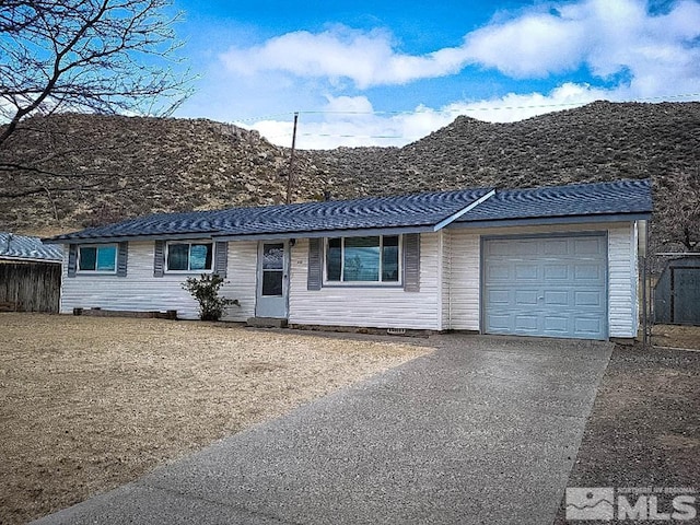 215 Palace Dr, Reno, NV 89506 - ranch-style home featuring asphalt driveway, an attached garage, and a mountain view
