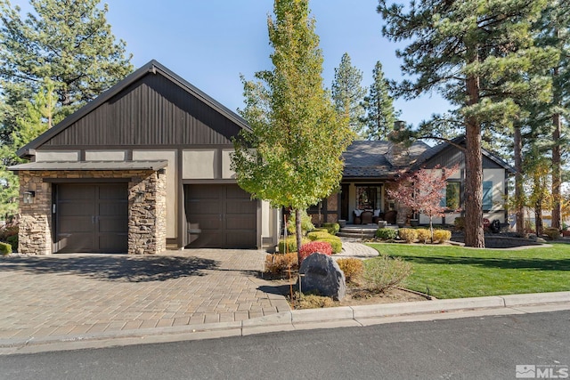 20588 Chanson Way, Reno, NV 89511 - view of front of property with stone siding, a garage, a front yard, and decorative driveway