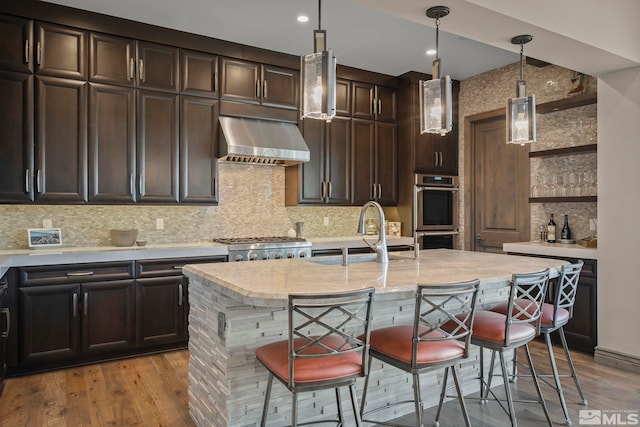 20588 Chanson Way, Reno, NV 89511 - kitchen with a sink, extractor fan, open shelves, appliances with stainless steel finishes, and a breakfast bar area