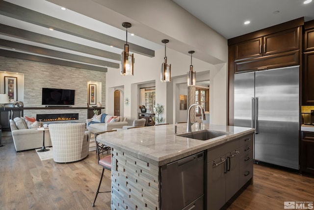 20588 Chanson Way, Reno, NV 89511 - kitchen featuring appliances with stainless steel finishes, a sink, dark wood-type flooring, dark brown cabinets, and beamed ceiling