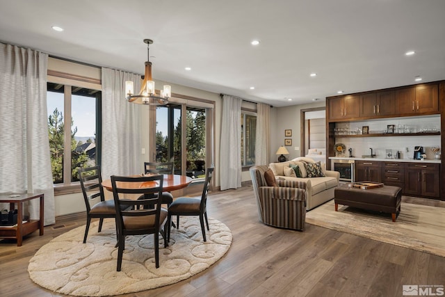 20588 Chanson Way, Reno, NV 89511 - dining area featuring recessed lighting, light wood-style floors, a chandelier, bar area, and beverage cooler