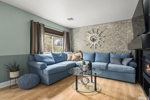 5625 Vista Luna Dr Unit 102, Sparks, NV 89436 - living room featuring wood finished floors and a glass covered fireplace