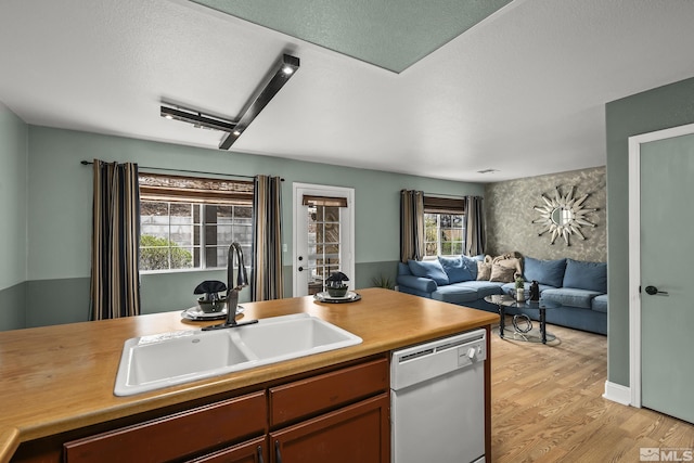 5625 Vista Luna Dr Unit 102, Sparks, NV 89436 - kitchen with dishwasher, a sink, light wood-style floors, open floor plan, and light countertops
