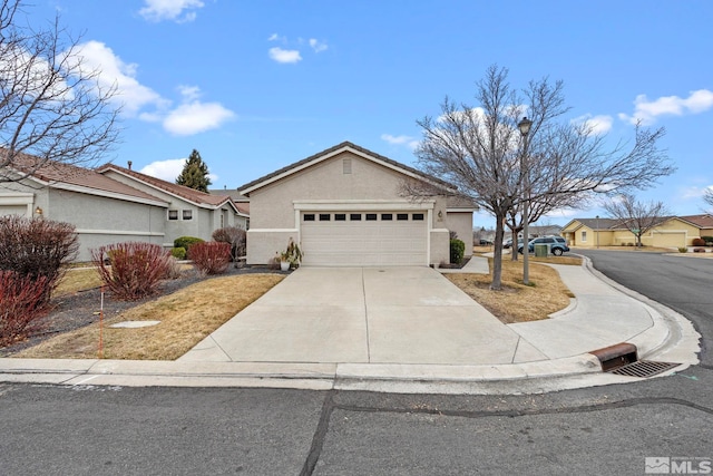 1676 Iron Mountain Dr, Reno, NV 89521 - ranch-style house with a garage, driveway, and stucco siding