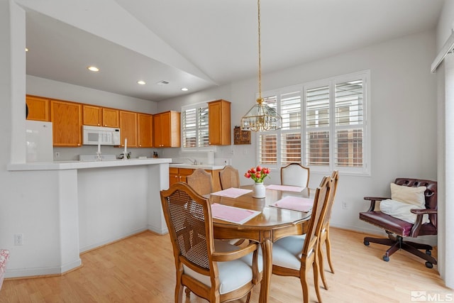 1676 Iron Mountain Dr, Reno, NV 89521 - dining room with a chandelier, light wood-type flooring, lofted ceiling, recessed lighting, and baseboards
