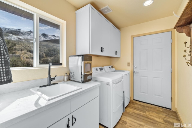 217 Shetland Cir, Reno, NV 89508 - laundry area featuring washer and clothes dryer, light wood finished floors, cabinet space, and recessed lighting