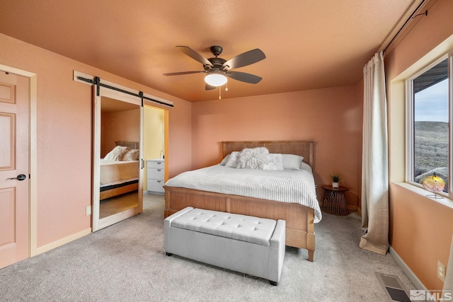 217 Shetland Cir, Reno, NV 89508 - bedroom featuring light carpet, a barn door, and baseboards