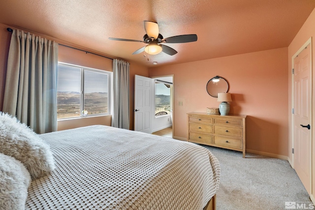 217 Shetland Cir, Reno, NV 89508 - bedroom with light colored carpet, baseboards, a ceiling fan, and a textured ceiling