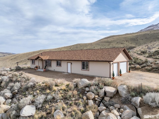 217 Shetland Cir, Reno, NV 89508 - view of front facade featuring stucco siding and a mountain view