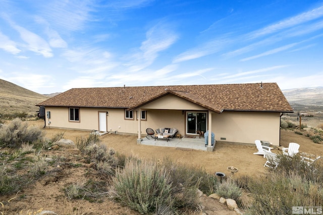 217 Shetland Cir, Reno, NV 89508 - back of house featuring stucco siding, a patio, and a mountain view