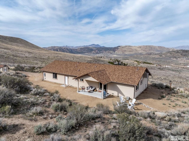 217 Shetland Cir, Reno, NV 89508 - back of property featuring stucco siding, a mountain view, and a patio area