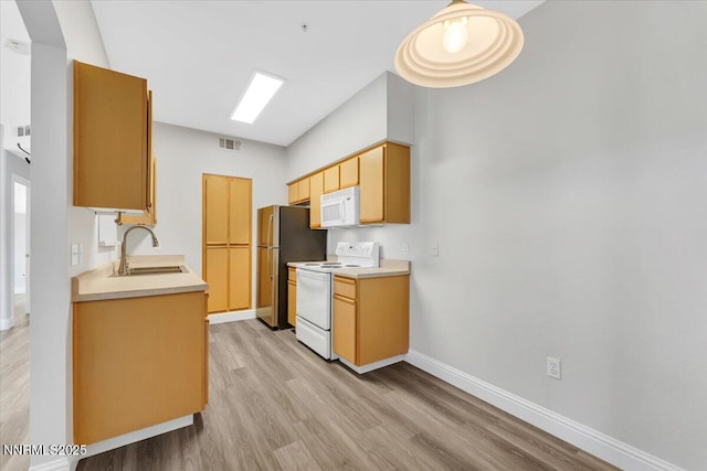 6850 Sharlands Ave Unit U1122, Reno, NV 89523 - kitchen featuring white appliances, light wood finished floors, a sink, and light countertops